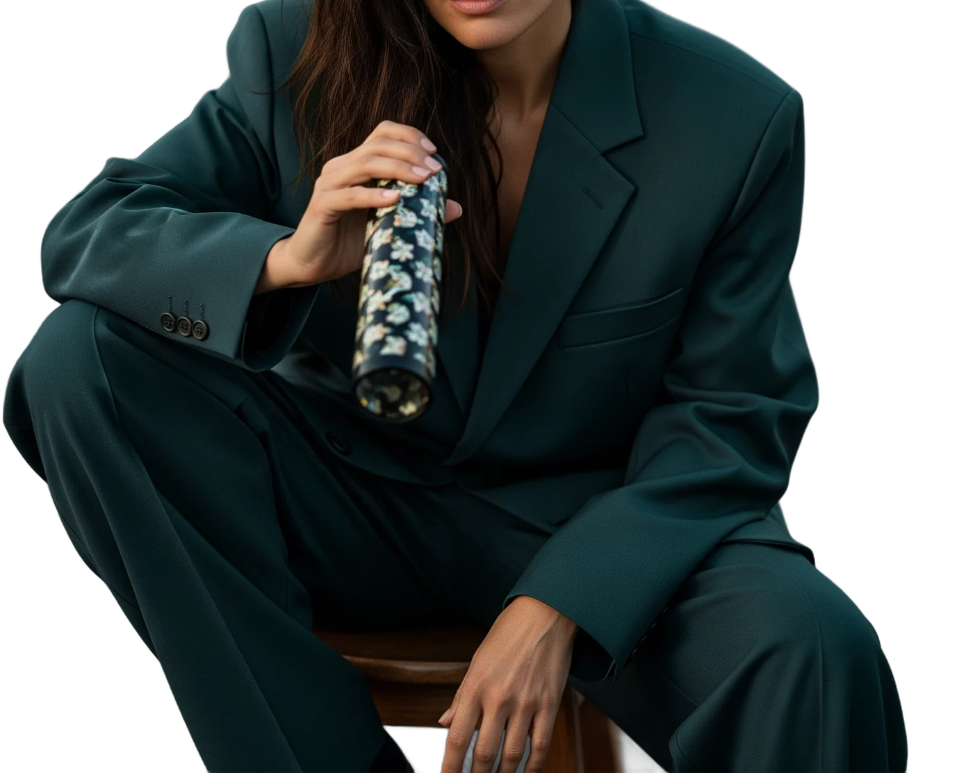 A woman in a teal suit holding a kaleidoscope
